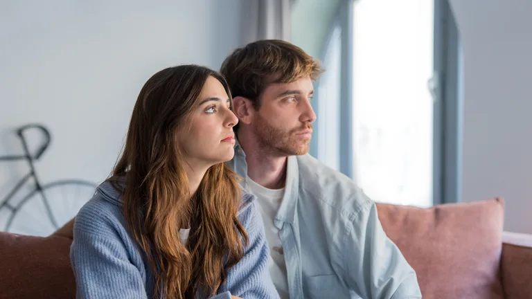 Couple working through a hard conversation at home — couples therapy in Arlington, Virginia