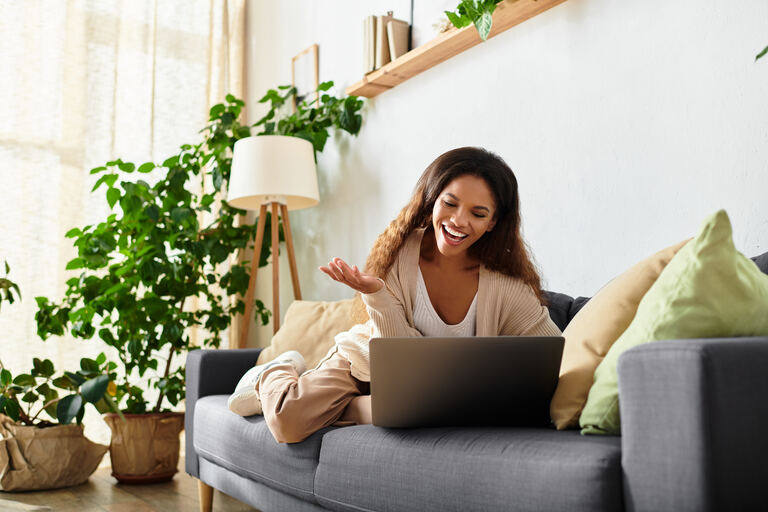 Woman connecting to a telehealth therapy session from her living room